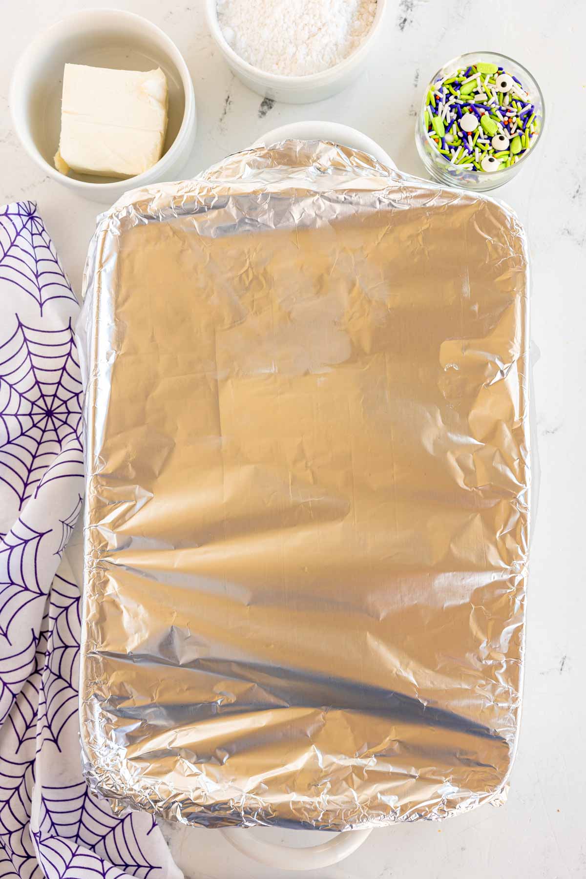 a white baking pan covered in foil