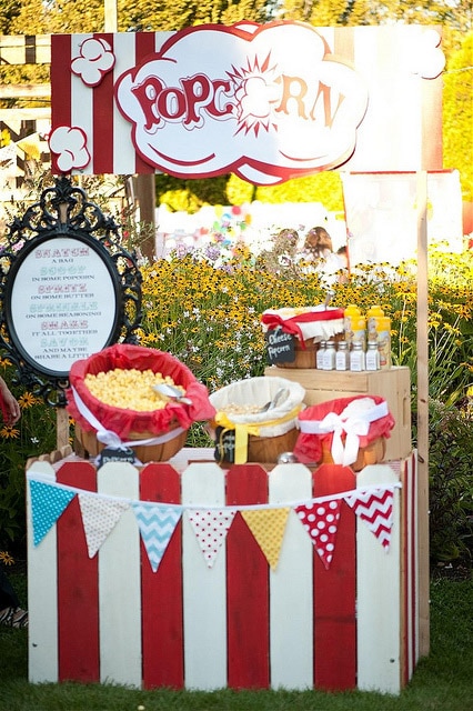 A popcorn bar doubles as circus party decorations and food