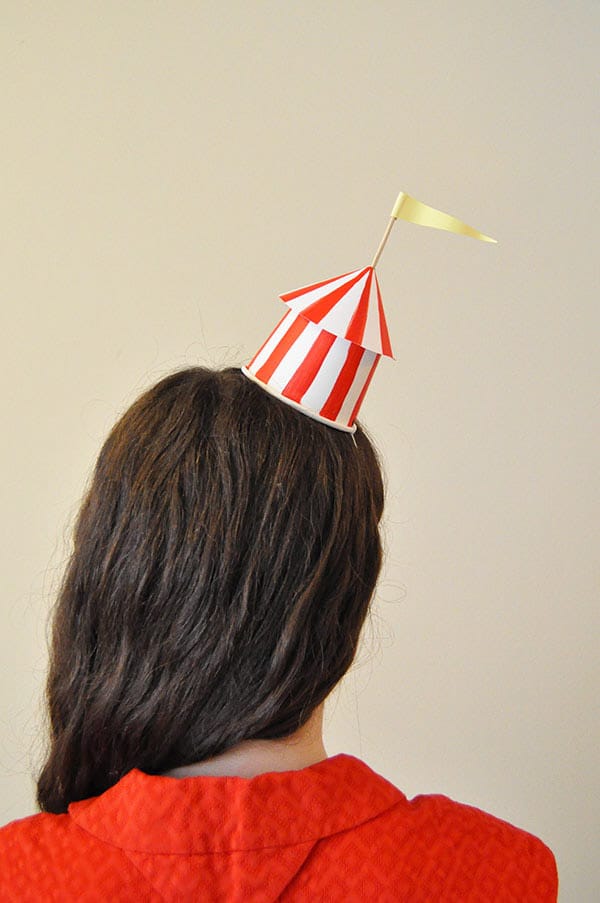 Circus party hat on top of a girl's head