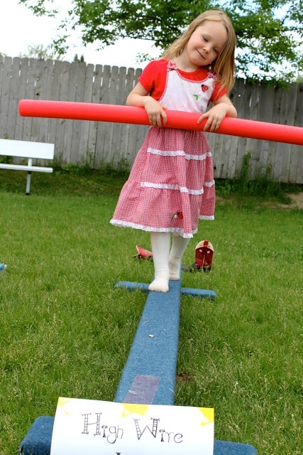 A girl walking a hire wire at a circus party