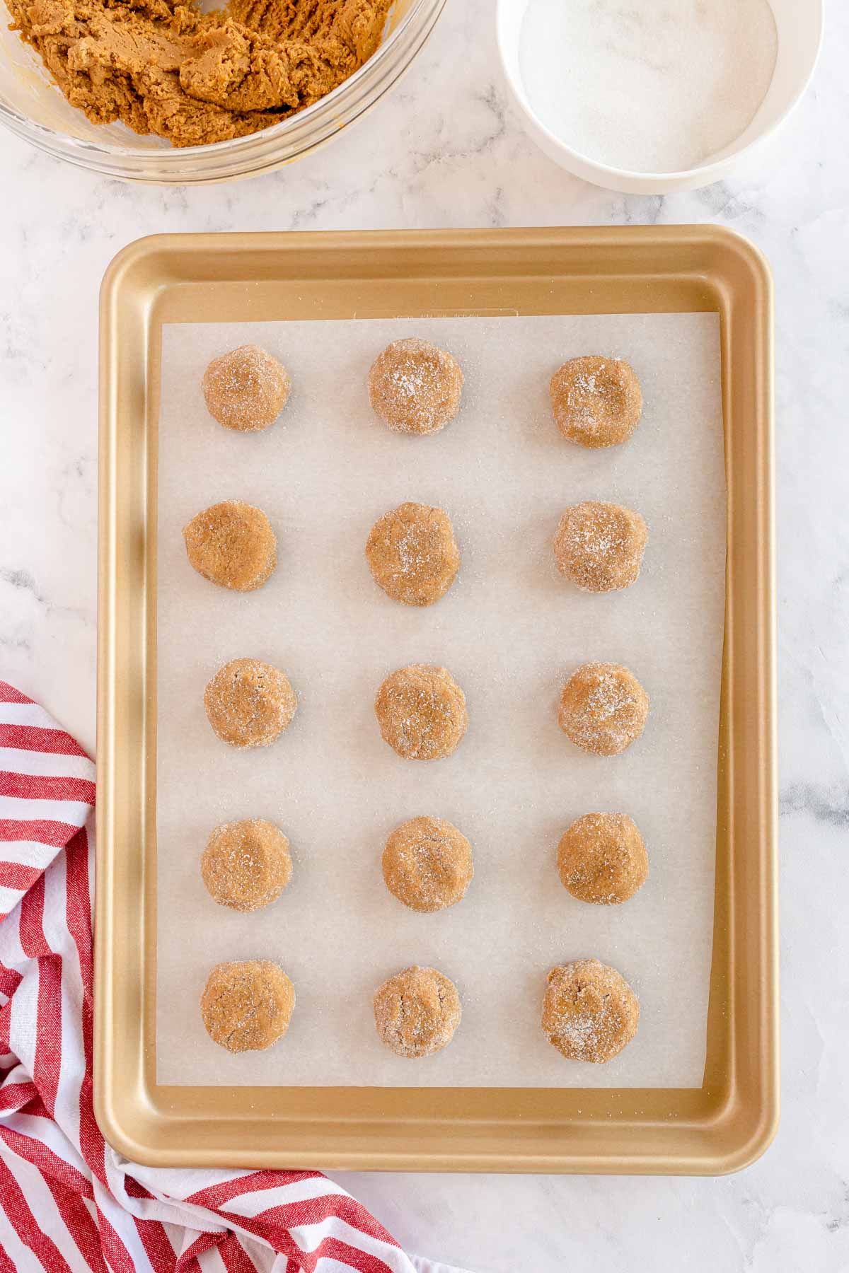 baking sheet with molasses cookie dough balls 