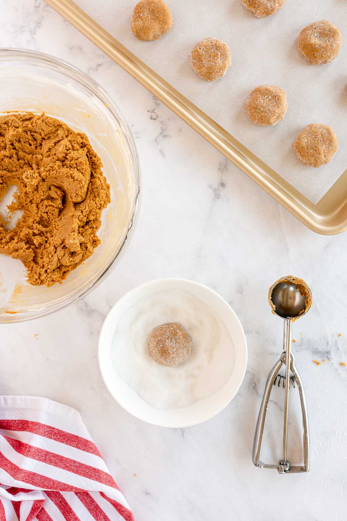 molasses cookie dough in a bowl with sugar