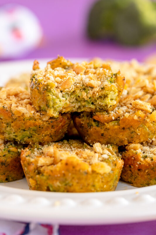 stacked pile of broccoli bites on a white cake stand