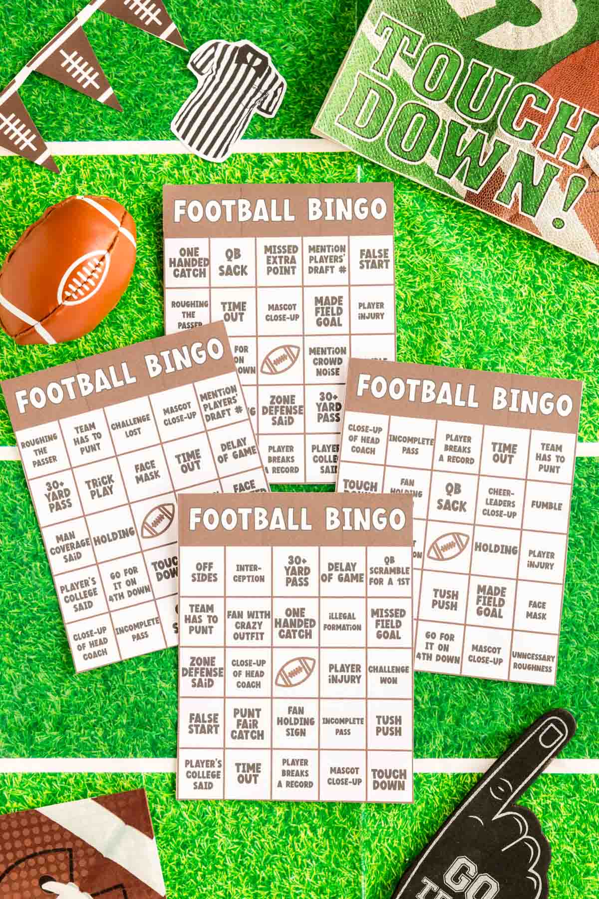 four football bingo cards on top of a green football field