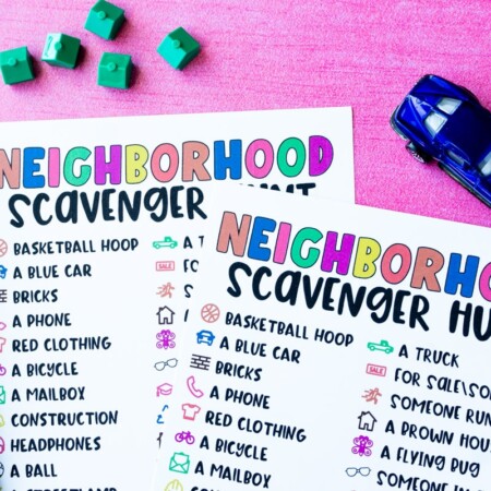 Neighborhood scavenger hunt on pink background with car and house toys