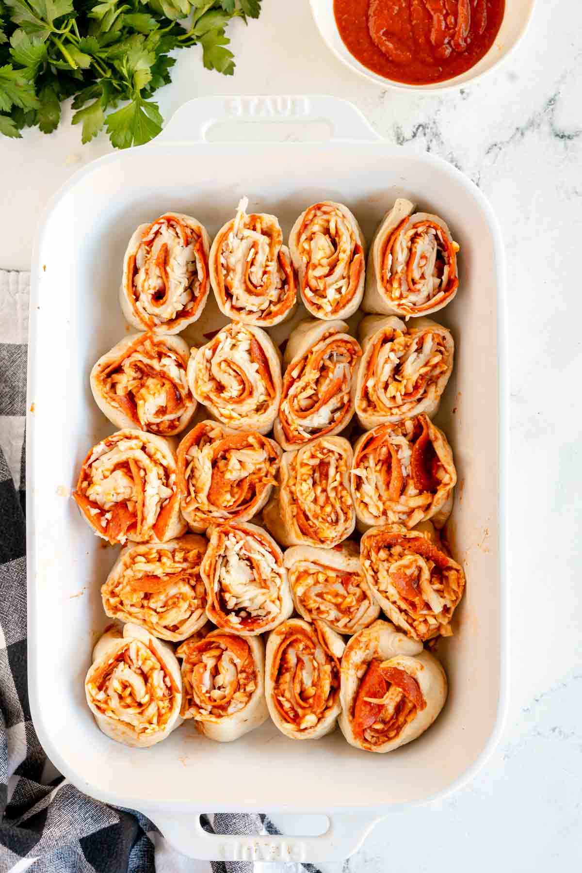 unbaked pepperoni rolls in a baking dish