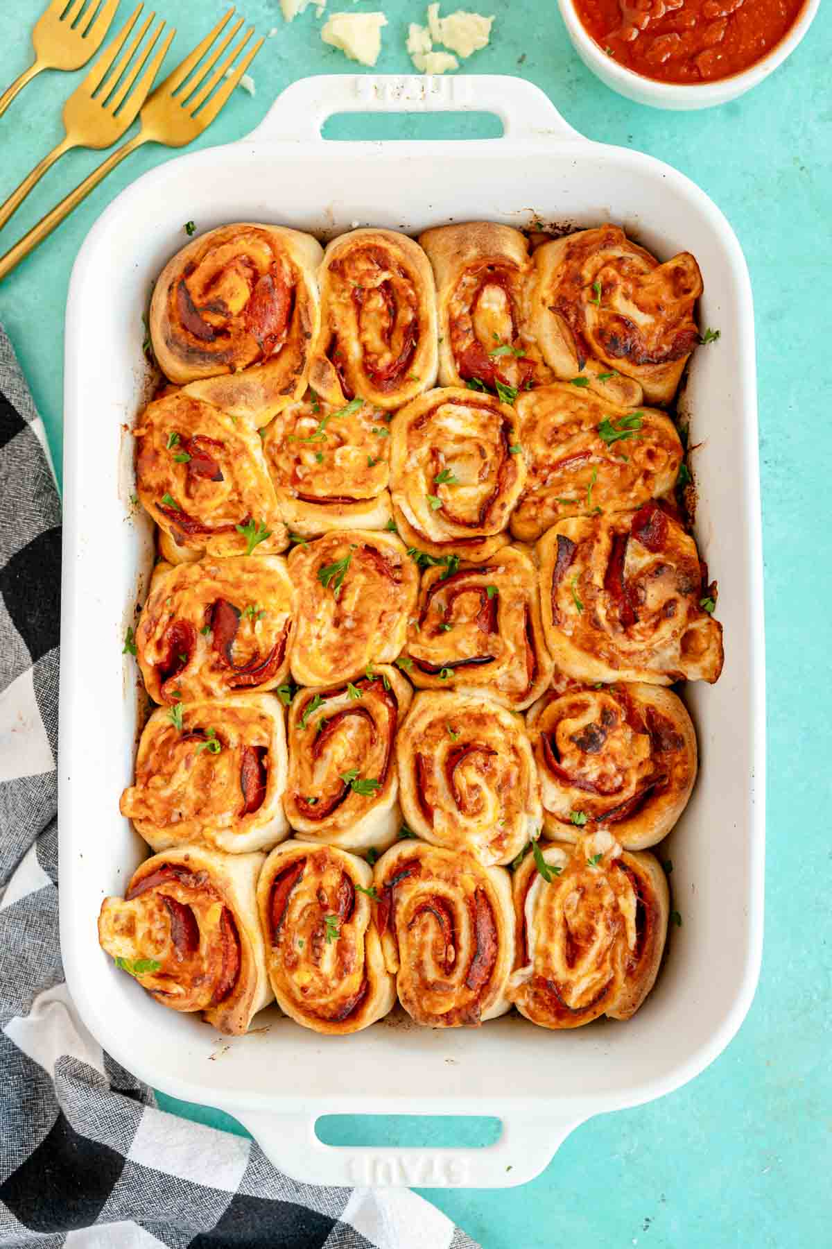 baked pepperoni rolls in a white baking dish