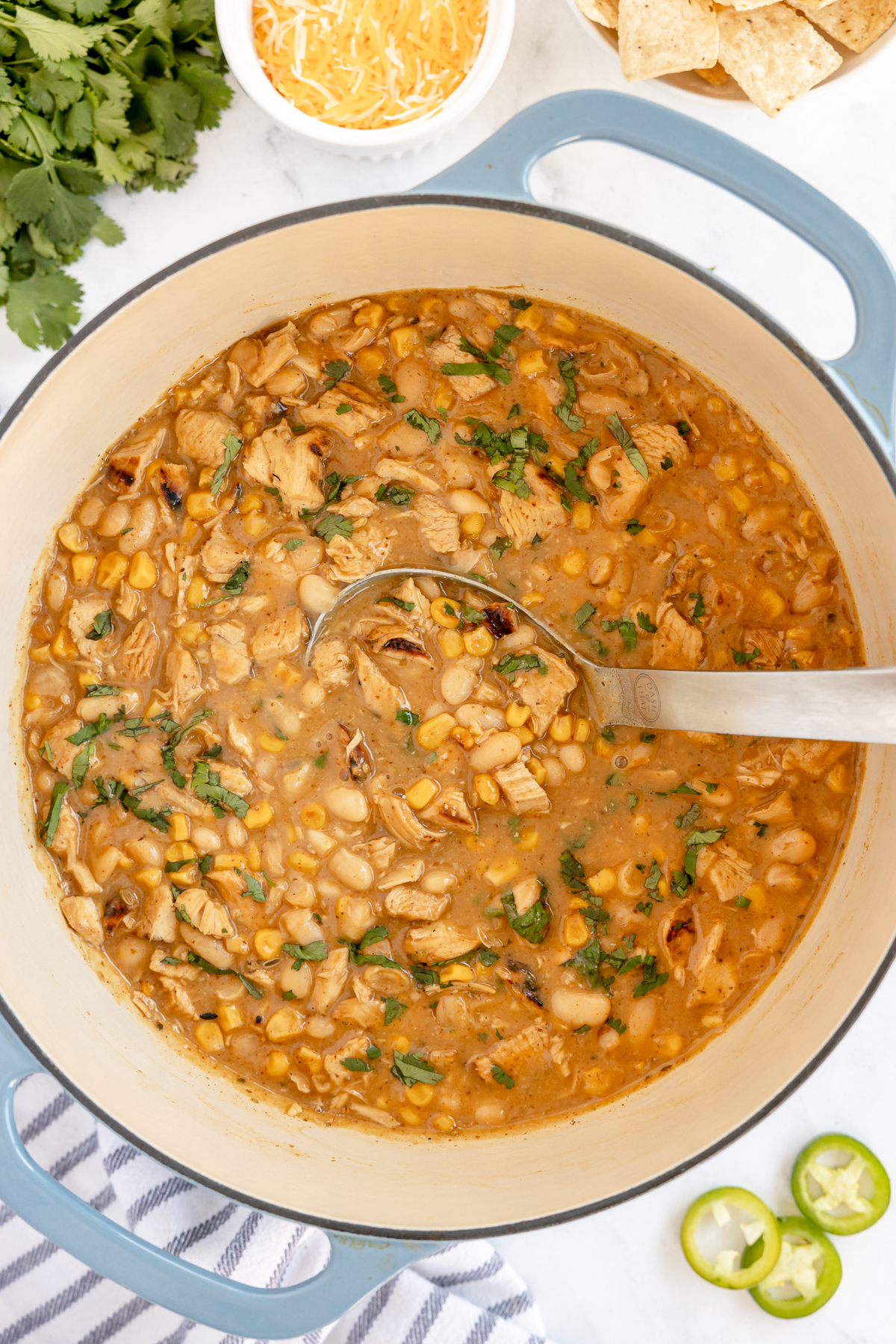 stock pot full of white chicken chili with a ladle 