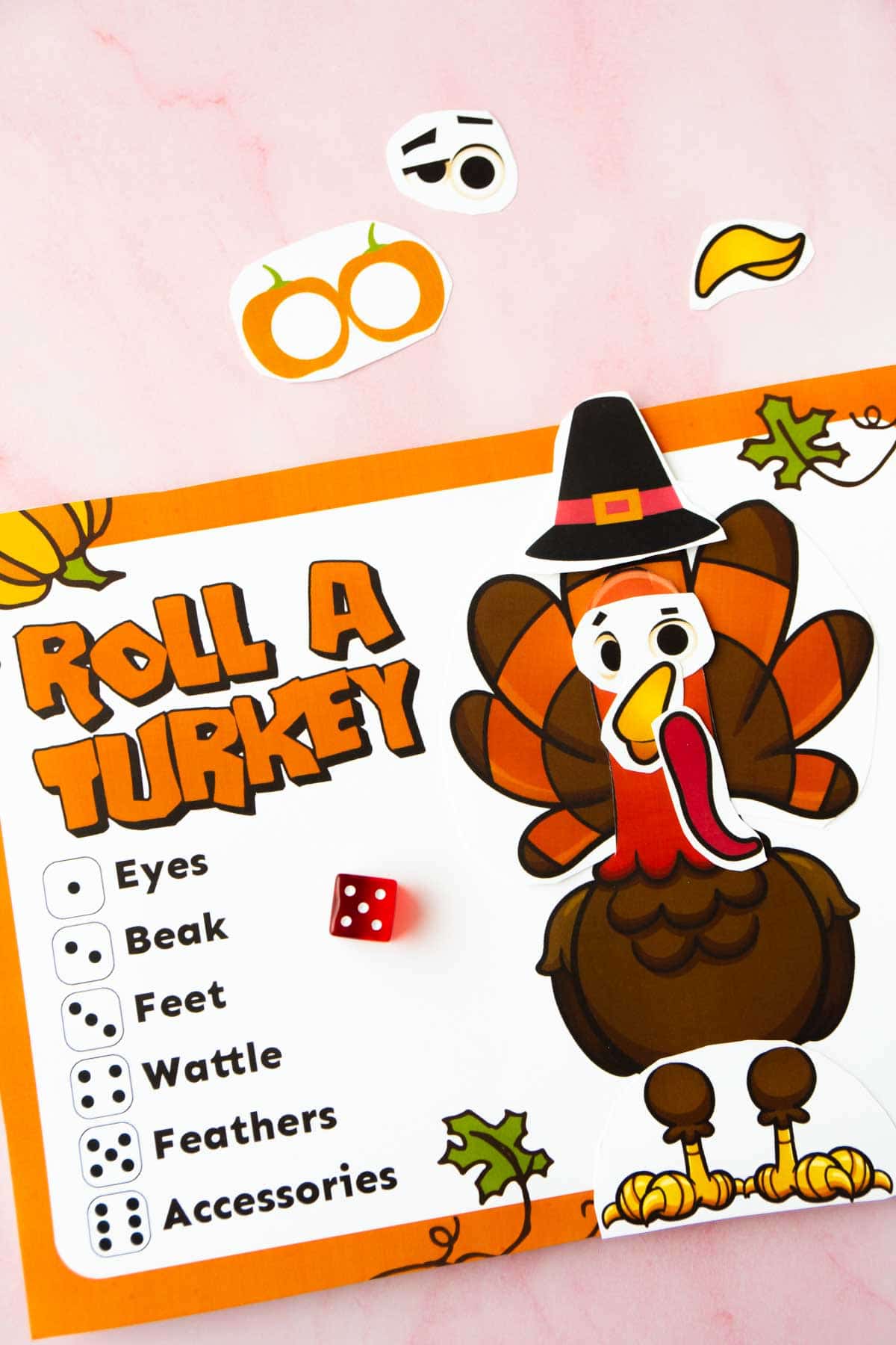 A printed out roll a turkey game with all the pieces added