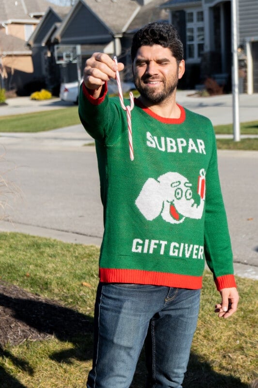 Man holding a candy cane hooked together