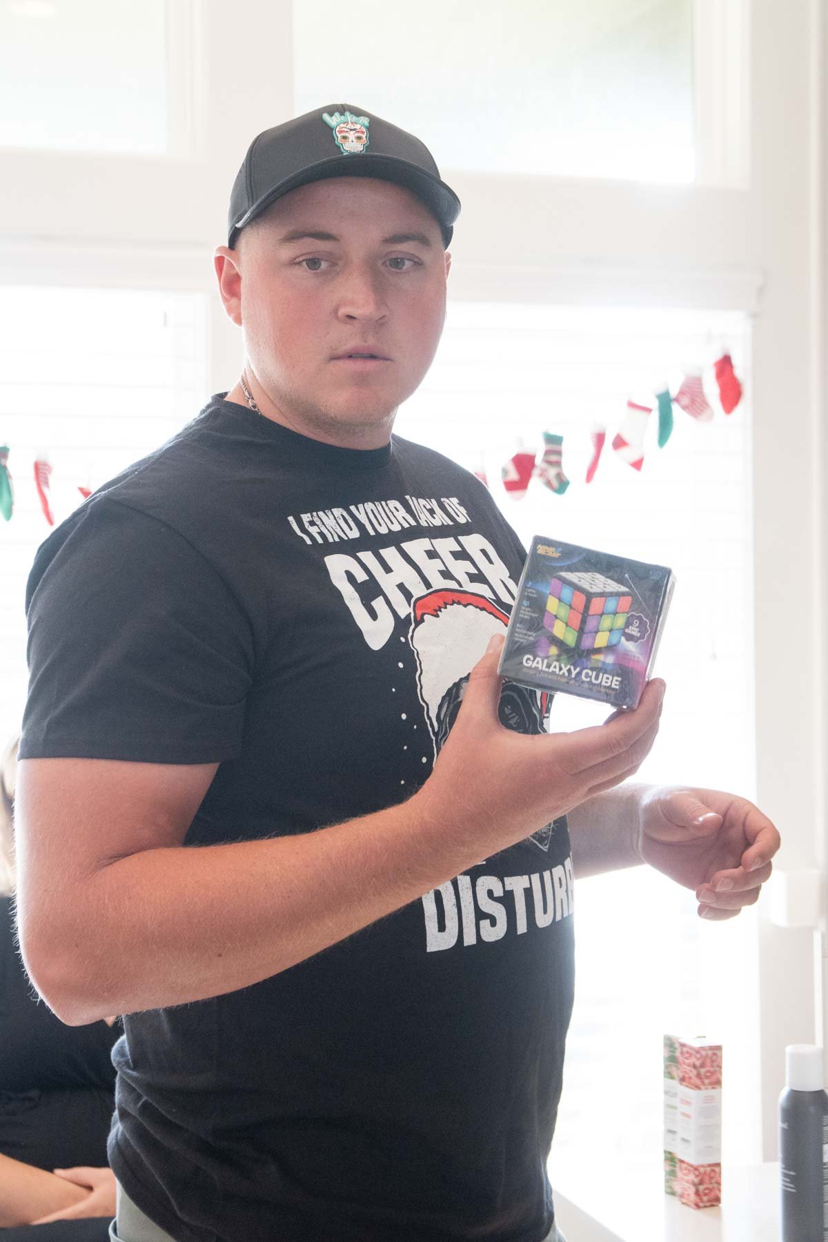 man holding a game cube Christmas prize