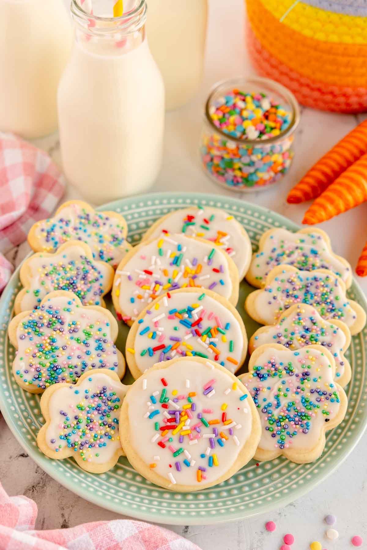 plate full of sprinkled cream cheese sugar cookies