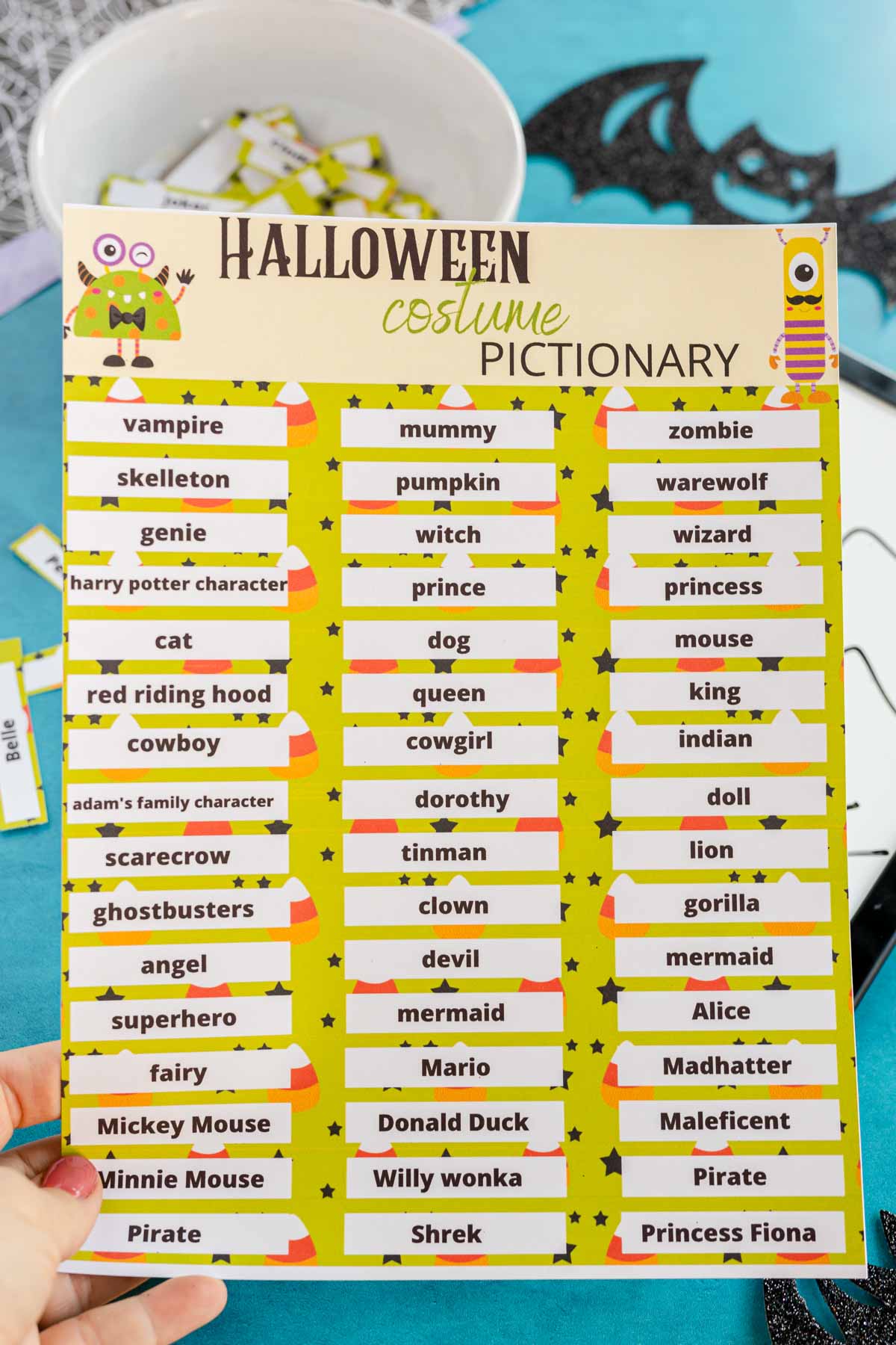 Halloween pictionary words held in someone's hand