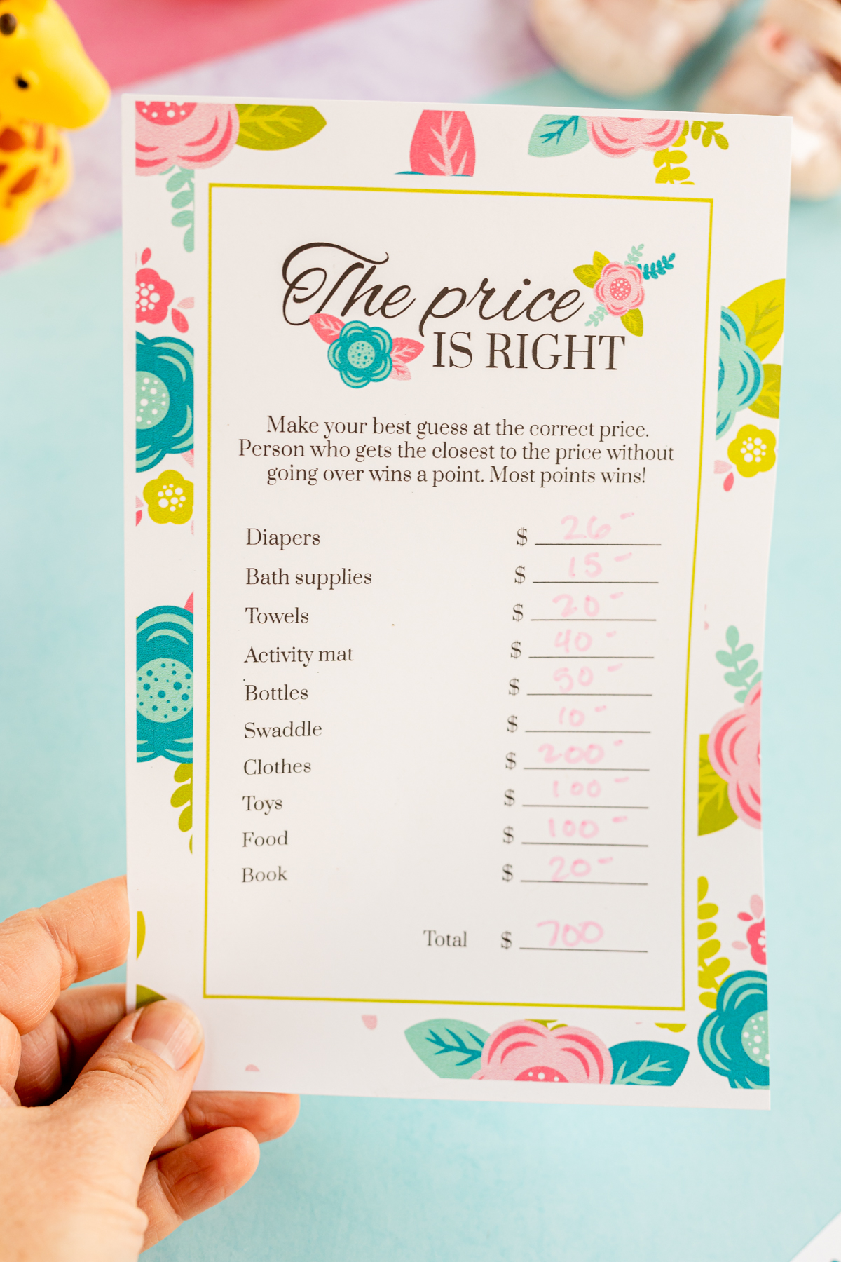 hand holding a baby shower price is right printable game