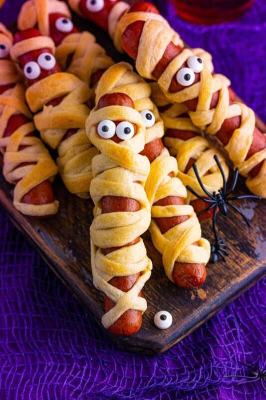 Mummy dogs for Halloween on a purple background