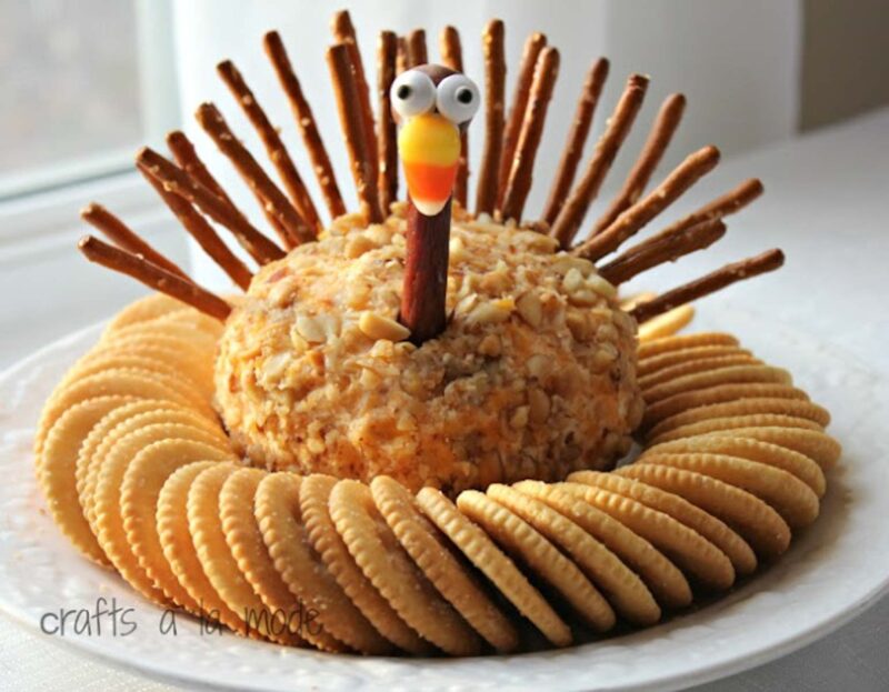cheeseball decorated like a turkey with crackers