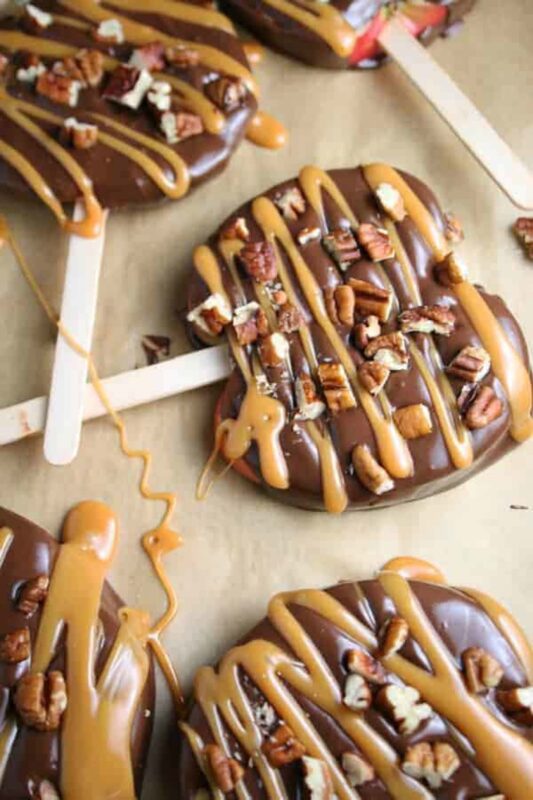 apple slices covered in chocolate with caramel topping