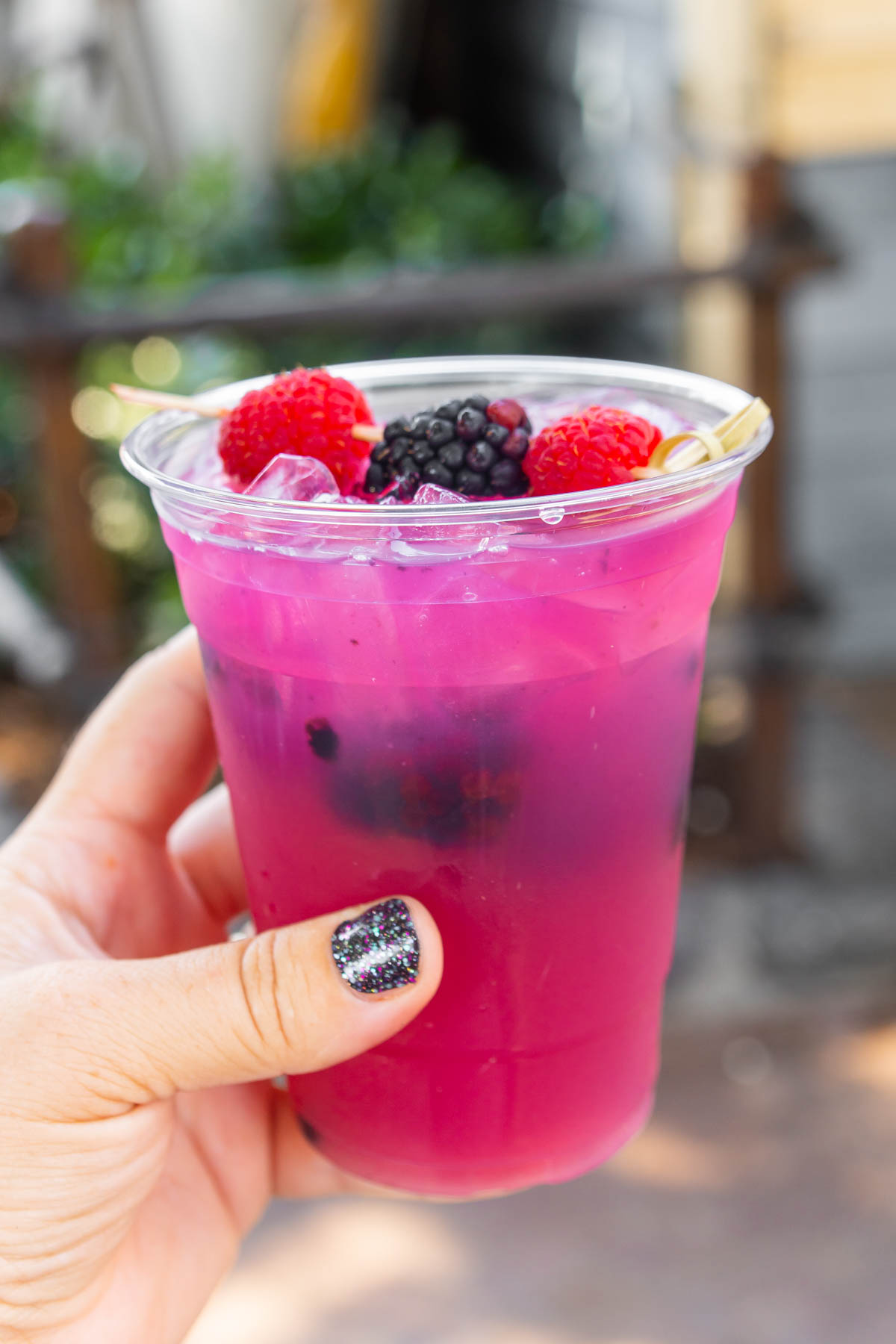 Hand holding a berry punch drink at Disneyland