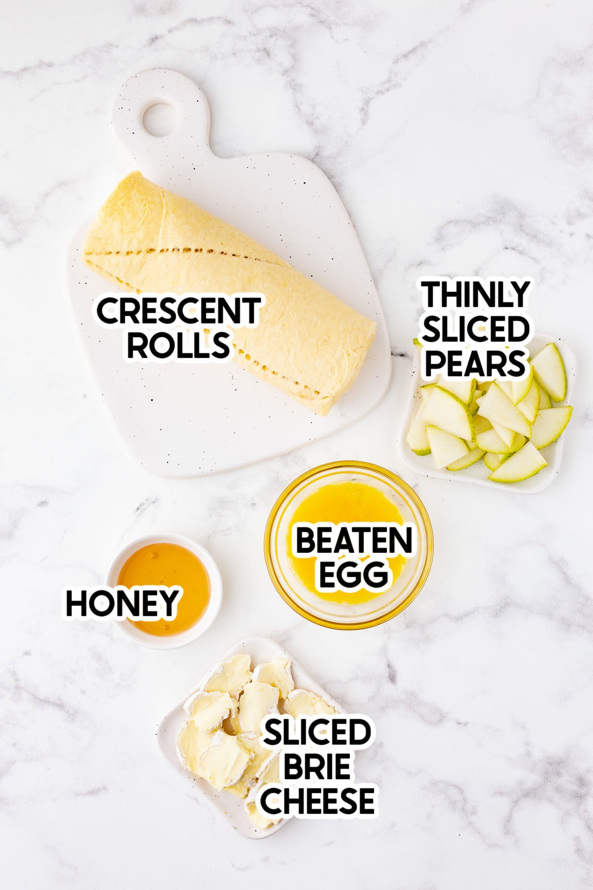 ingredients to make a brie and pear appetizer with labels