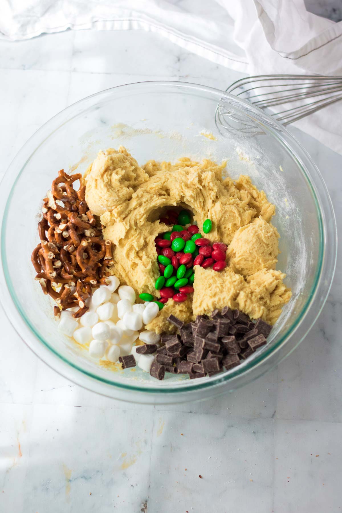 glass bowl with ingredients to make Christmas kitchen sink cookies