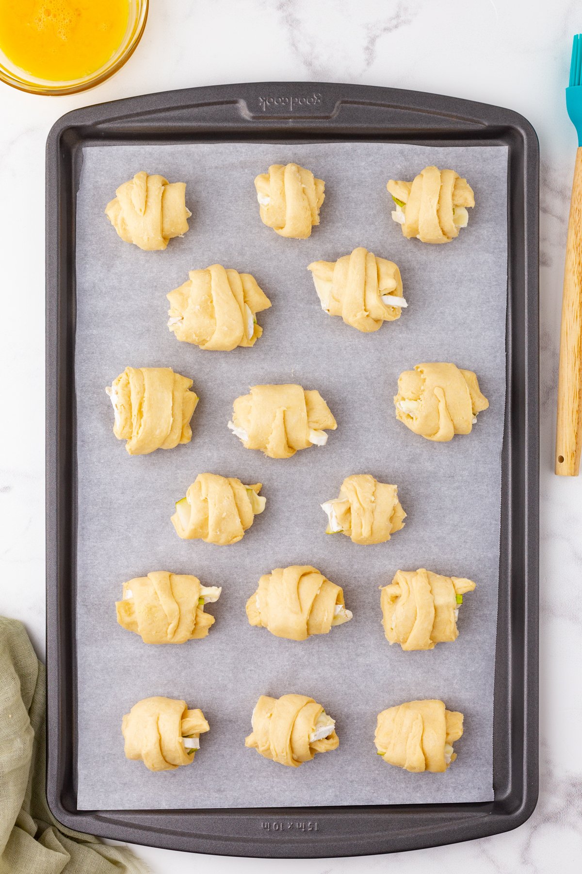 wrapped up brie and pear appetizers ready to be baked