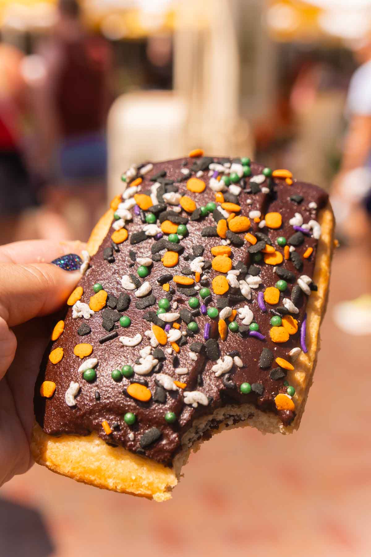 Hand holding a chocolate tart at Disneyland