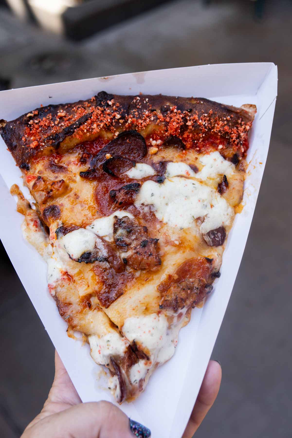 slice of spicy meats pizza at Disneyland