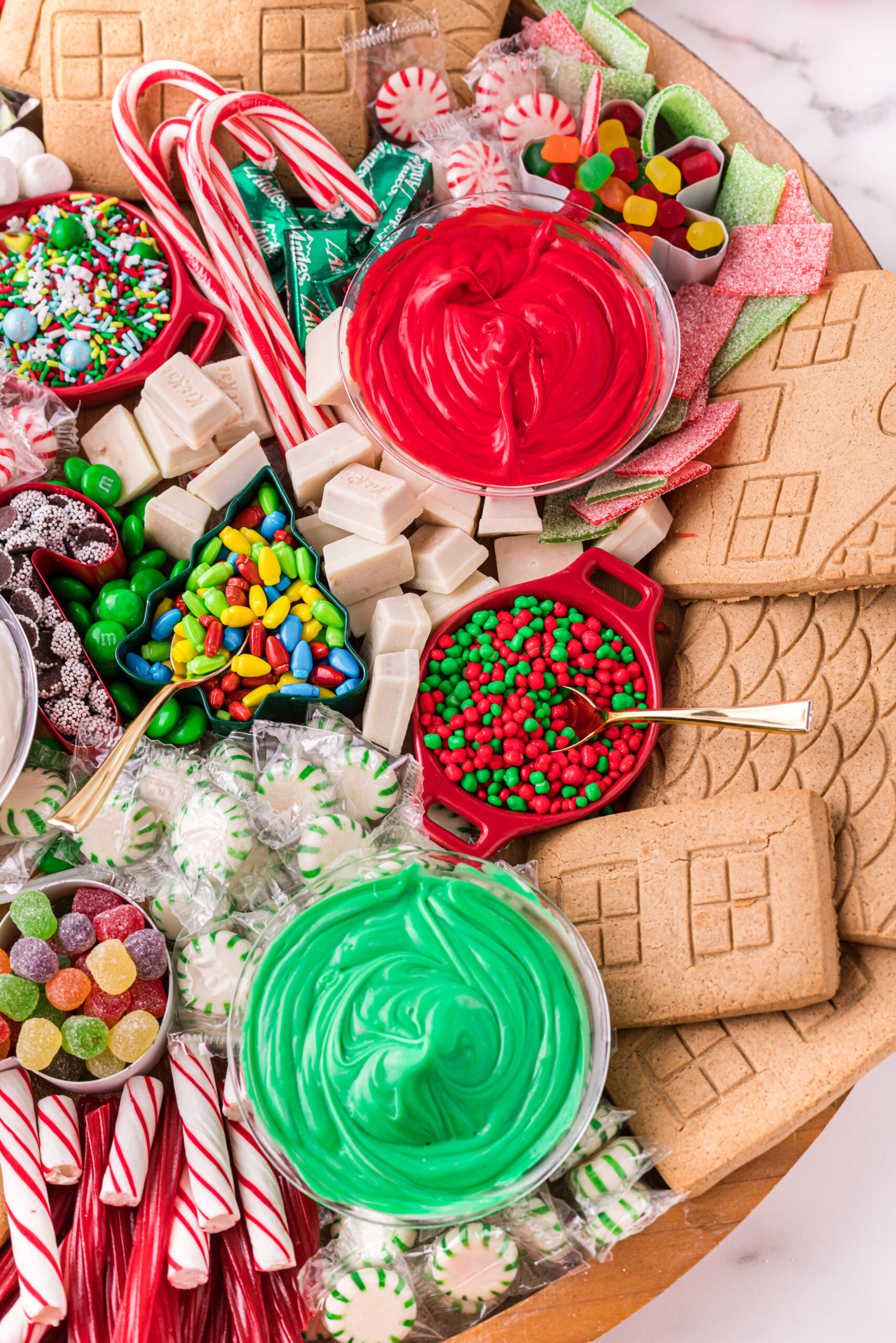 toppings to build gingerbread houses on a gingerbread charcuterie board