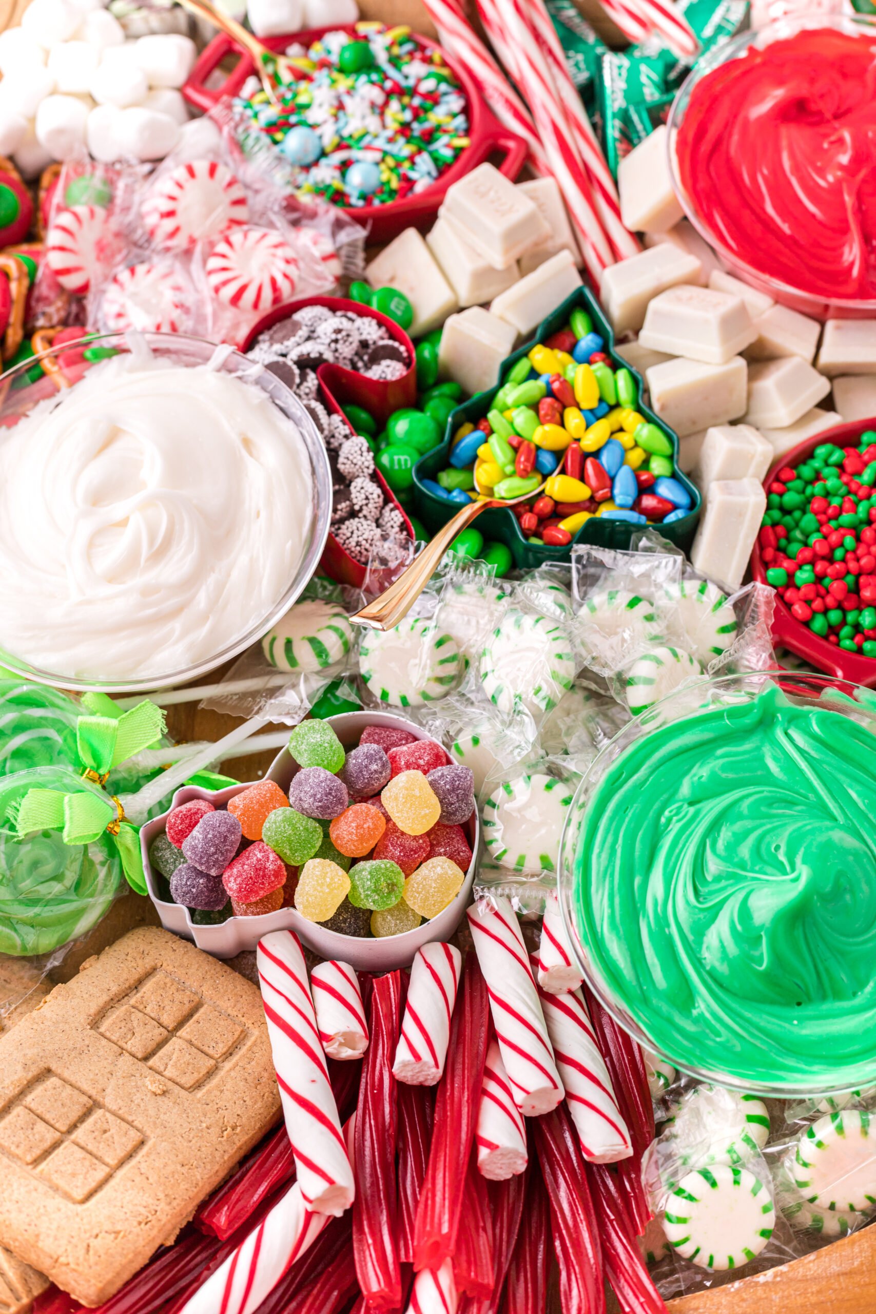 piles of candy on a gingerbread house charcuterie board