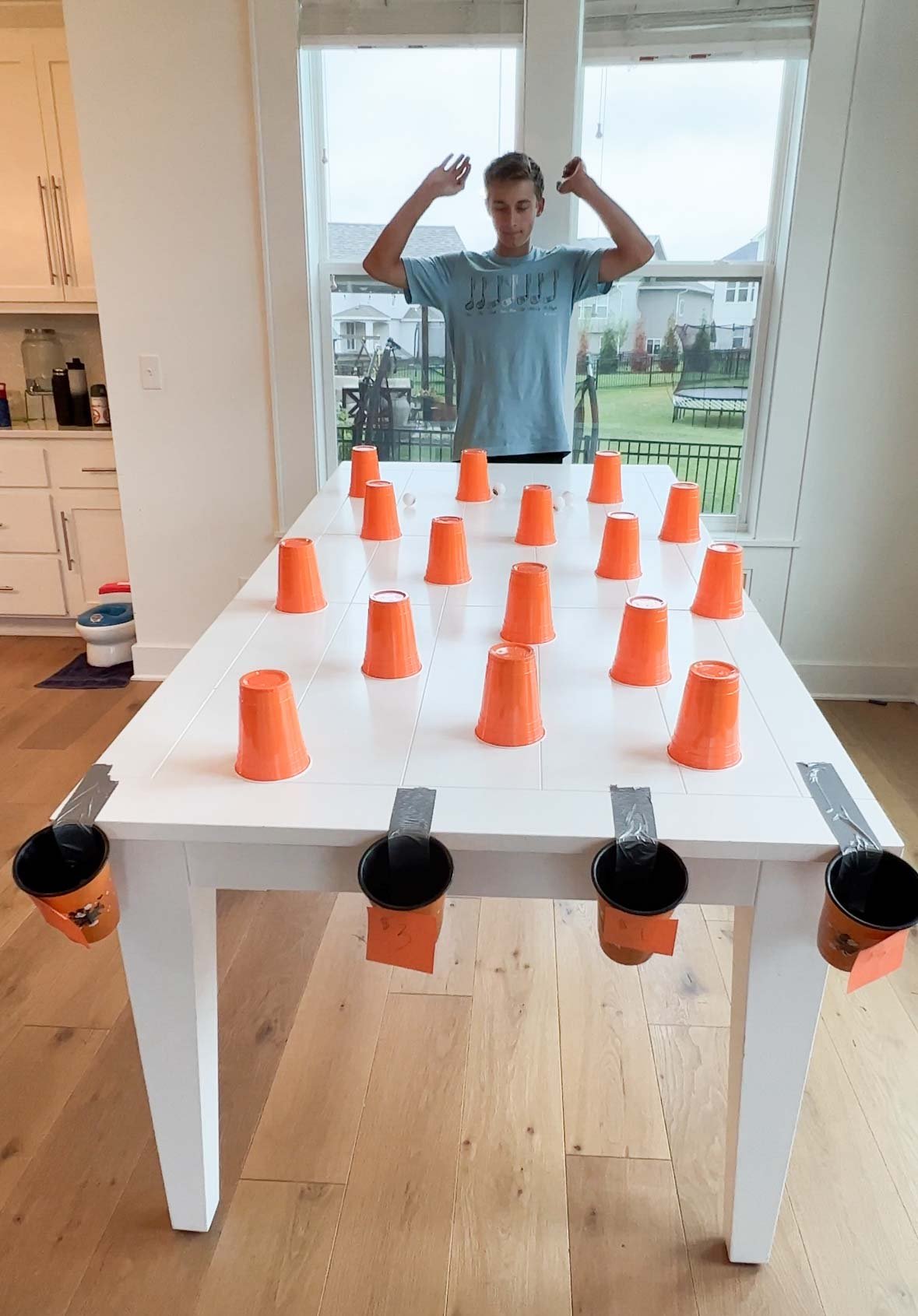 a Halloween plinko game with plastic cups and prize buckets