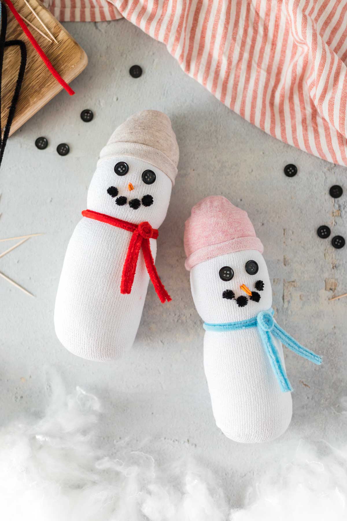 two sock snowman with stuffing all around them 