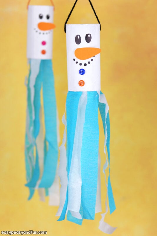 toilet paper rolls with snowman faces and streamer tassels