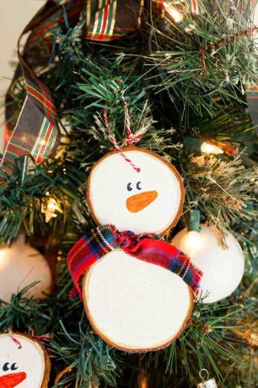 wooden slices with white paint and snowman faces