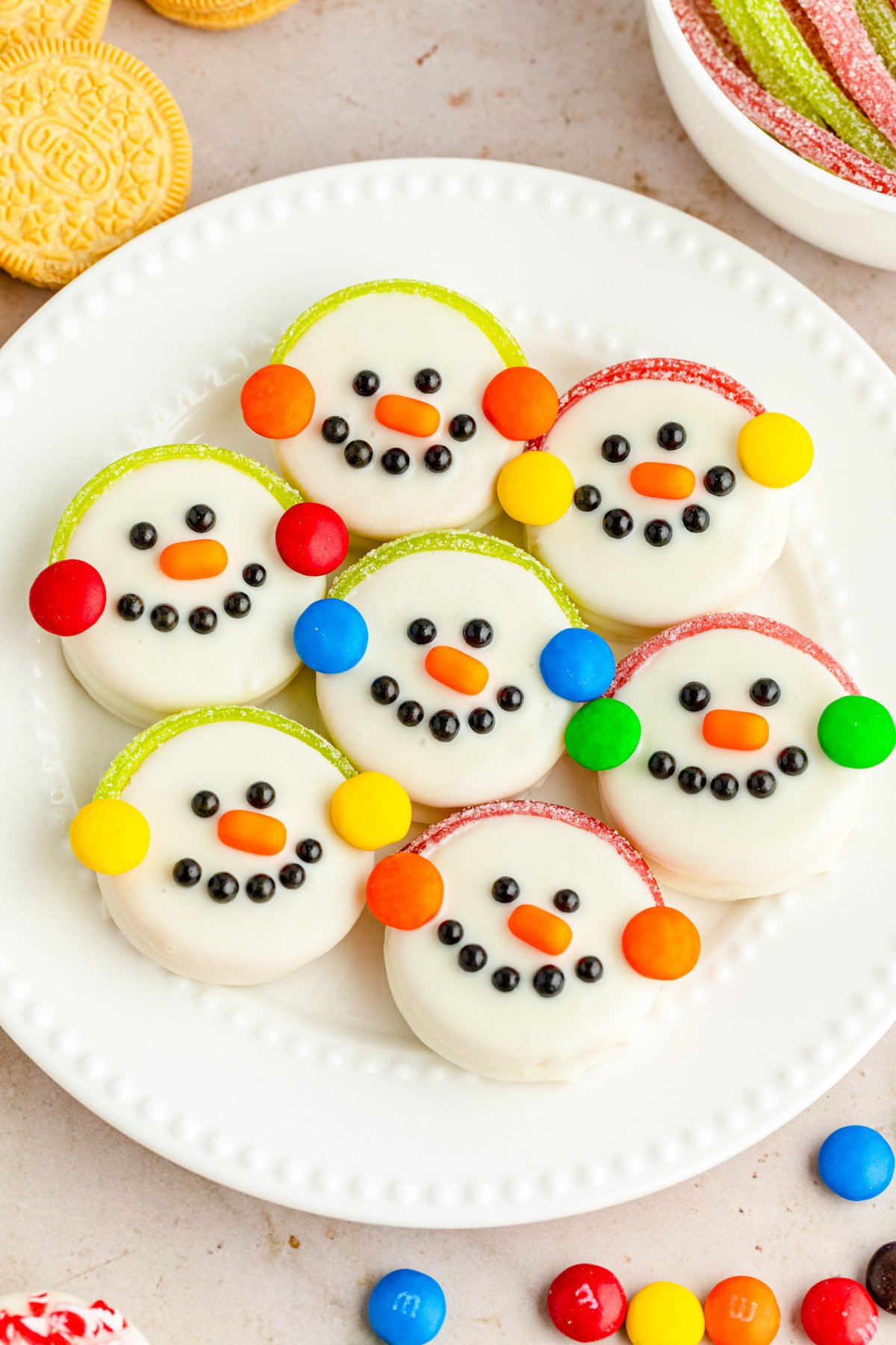 white plate with Oreo snowman cookies on them