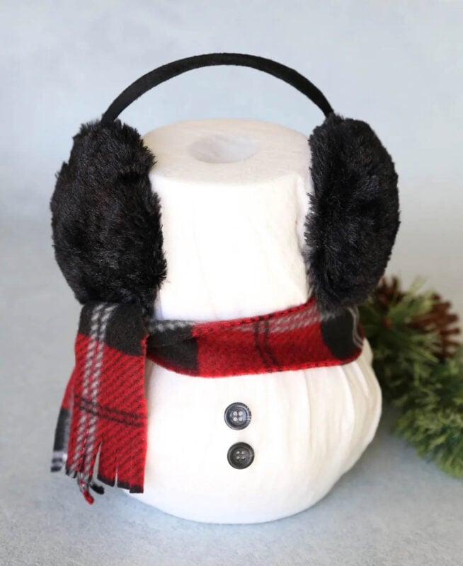 stacked toilet paper roll with scarf and ear muffs