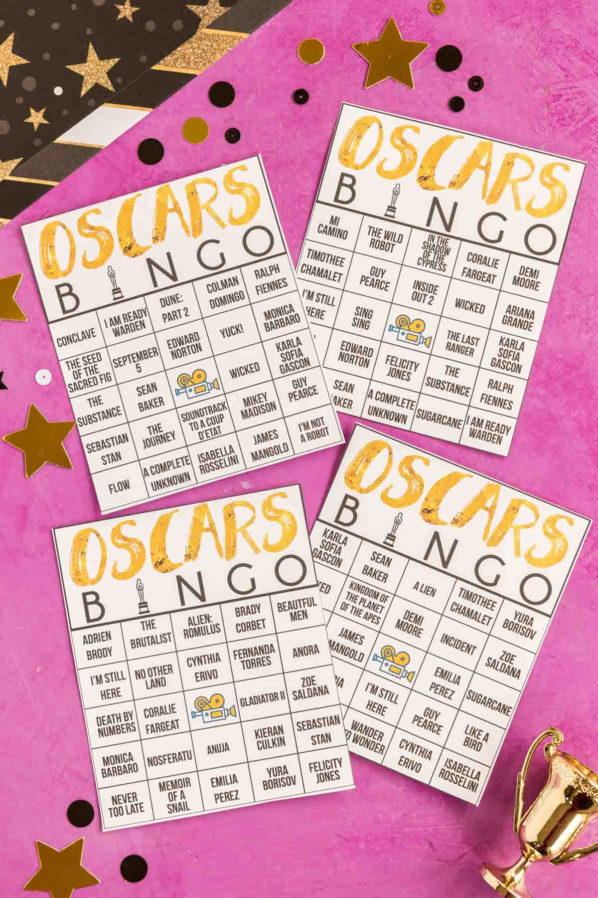 four Oscar bingo cards on a pink background