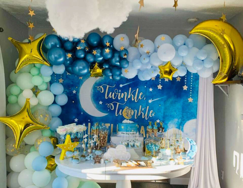 various blue balloons and gold stars with twinkle little start banner