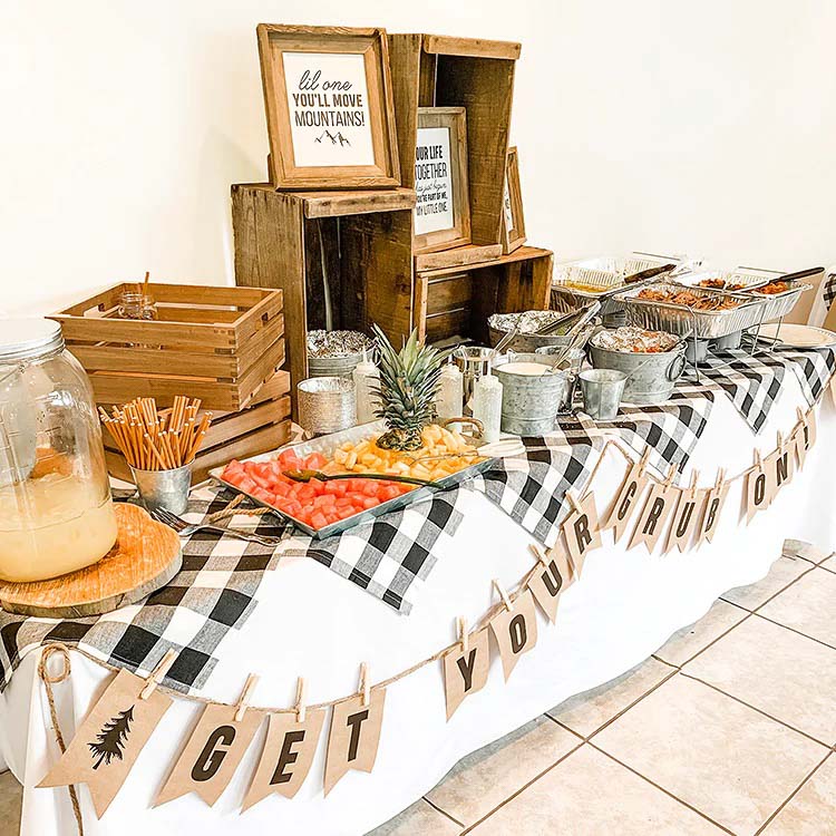 gingham table cloth with variety of wooden crates that hold food