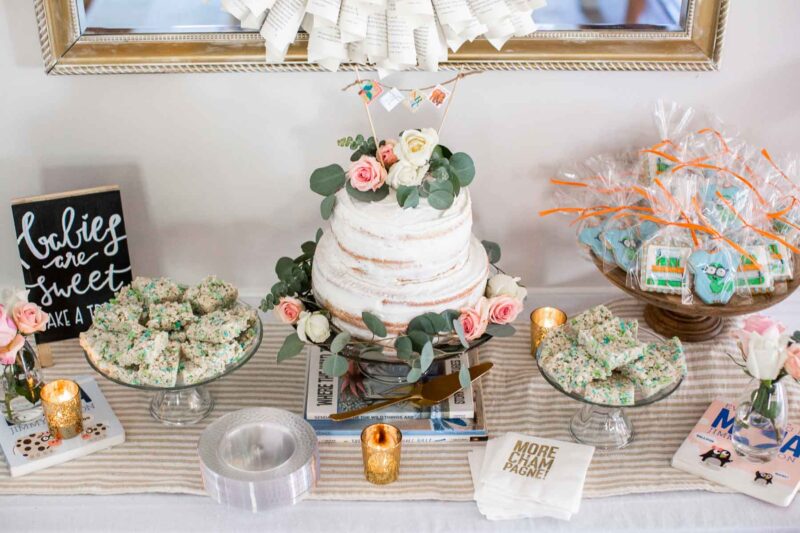 dessert table setting with a variety of book accents such as napkins and bookworm cookies