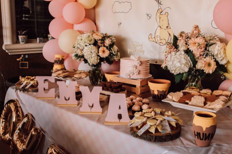 winnie the pooh background with honeypots and sweet treats on a table