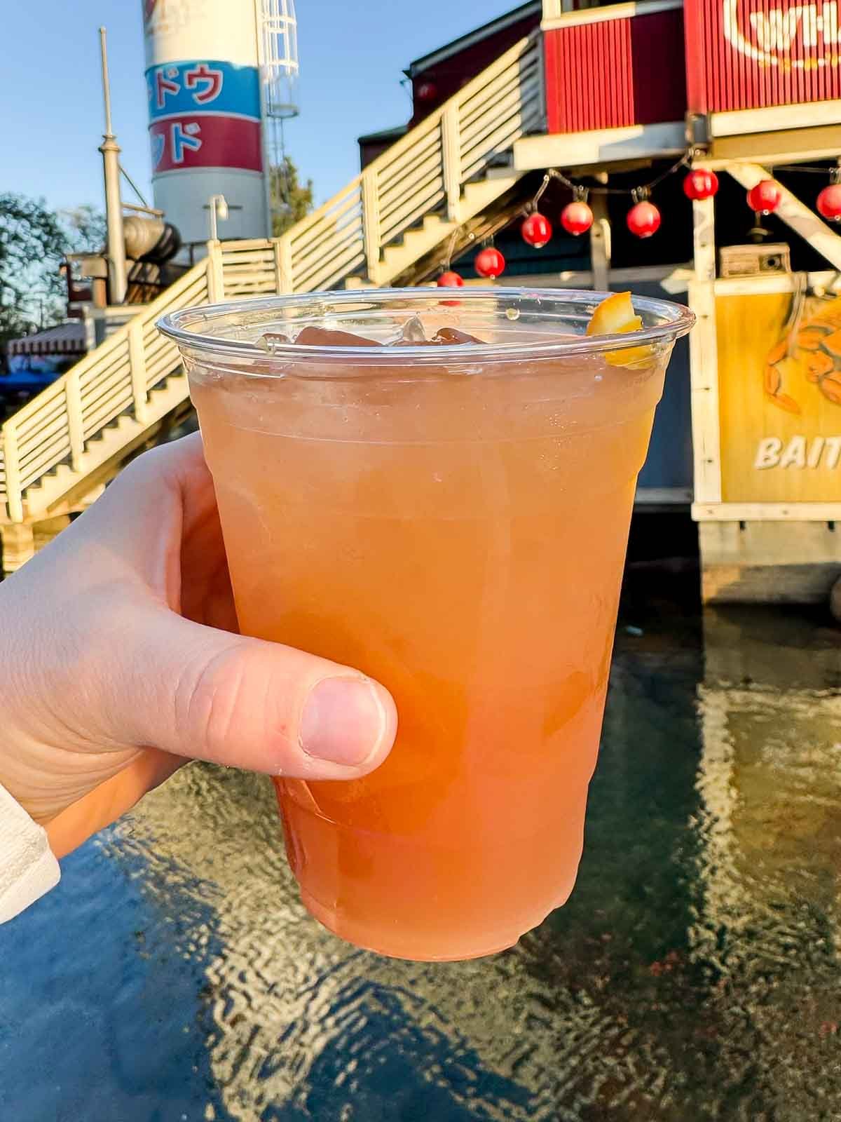 hand holding a huckleberry citrus cooler at disneyland 