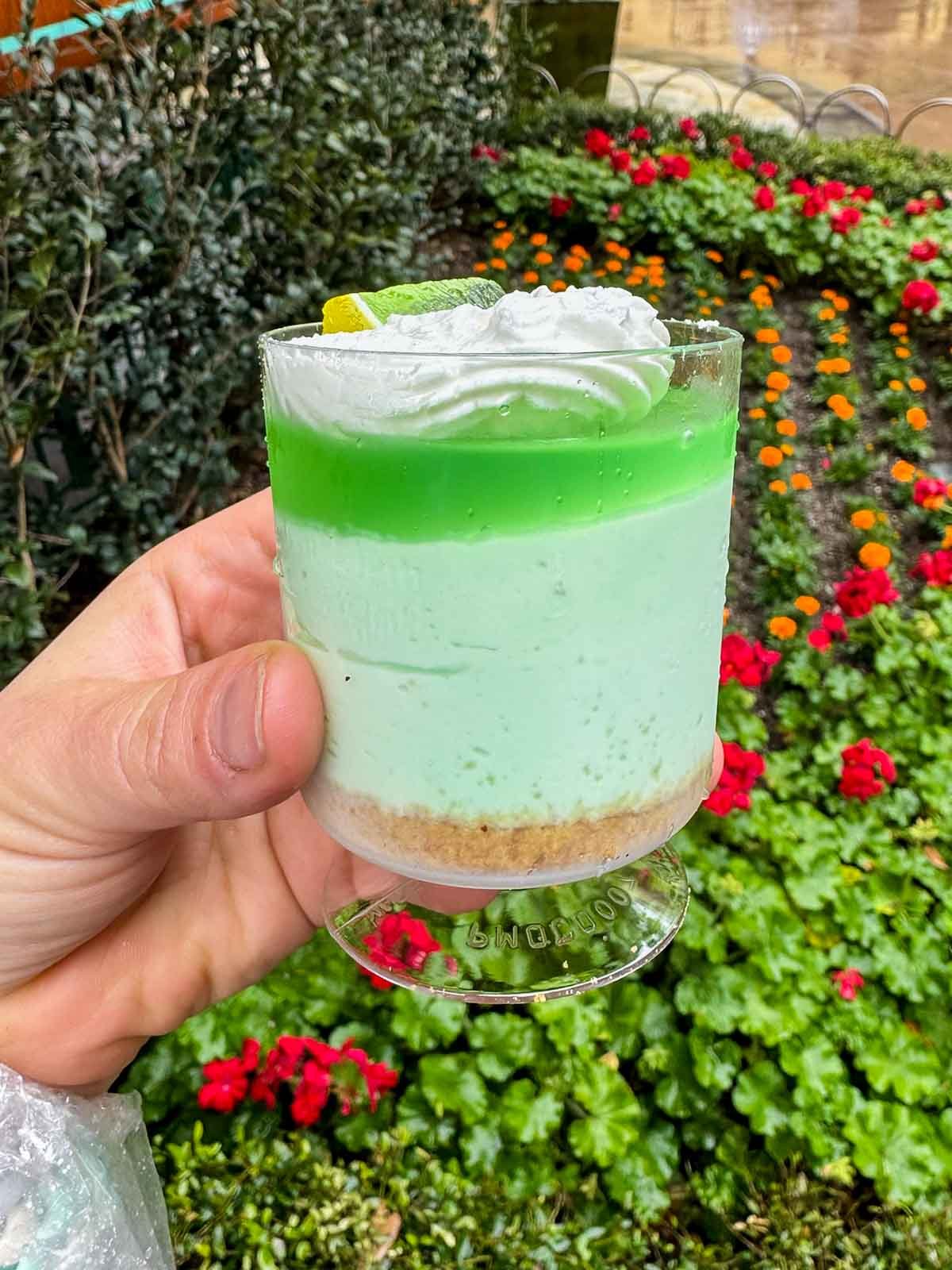 hand holding a lime parfait at disneyland food and wine festival