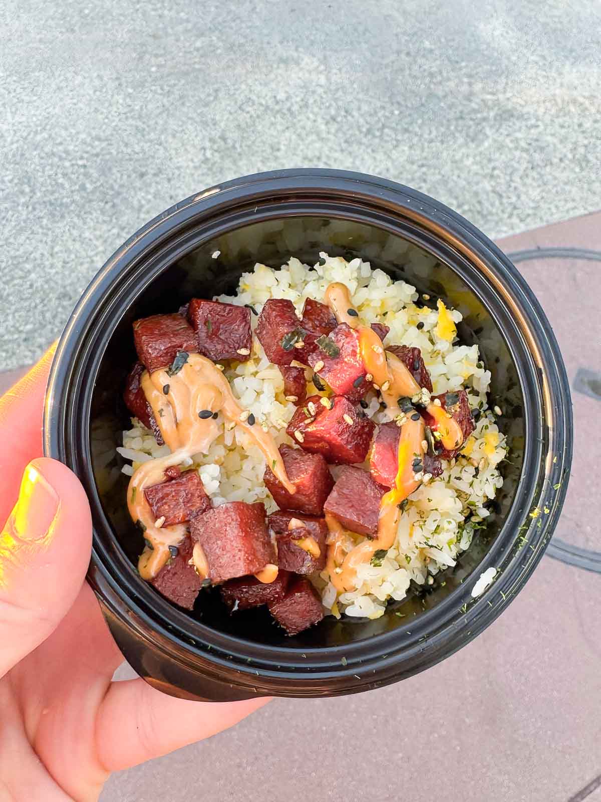 hand holding a fried rice dish at the Disneyland food and wine festival 