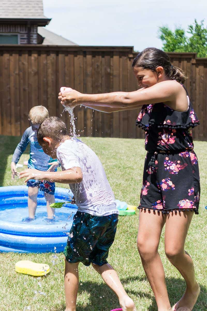 kid dumping water on another kid