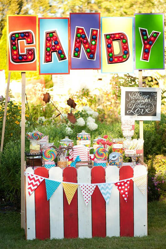 red and white stand with a candy sign