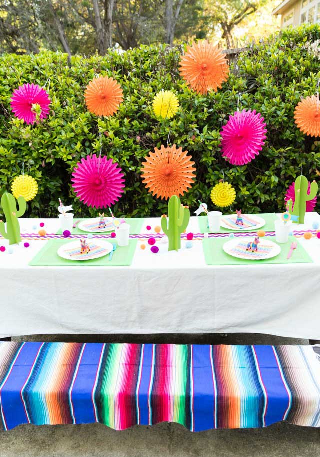 bright colored fiesta table with paper catuses