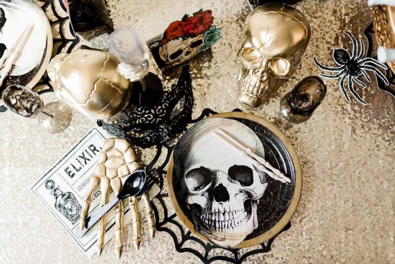 gold table setting with skull decorations