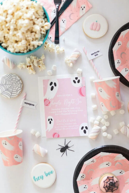 pink ghost table setting with various themed cookies