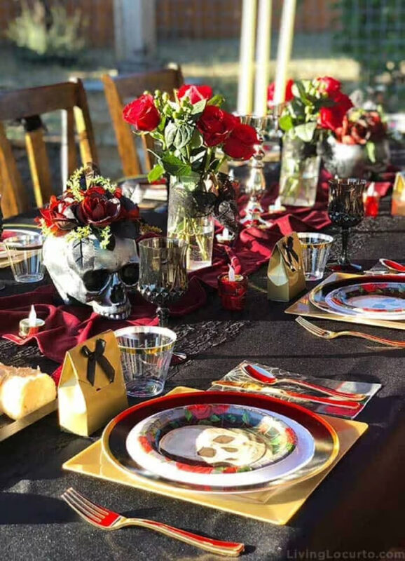 black table setting with skulls and roses