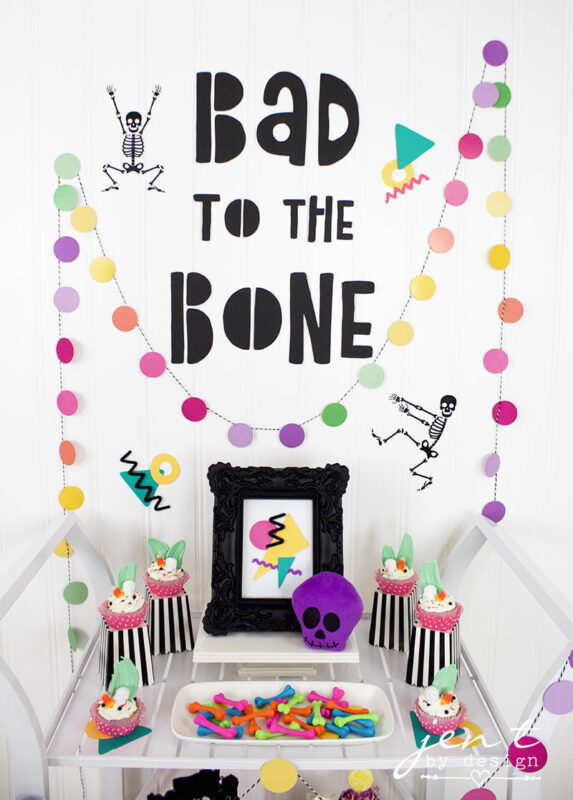 neon colored decor with dancing skeletons and cupcakes on a table setting